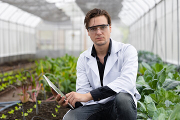 portrait agriculture scientist man working plant research in bio farm laboratory.biologist study collecting data with laptop computer.