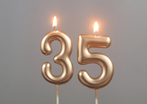 Burning Gold Birthday Candles On Gray Background, Number 35