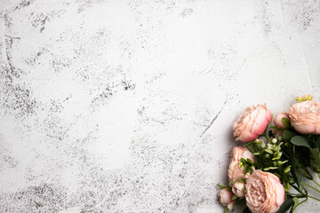 Pink roses bouquet over the grey background with copy space. 