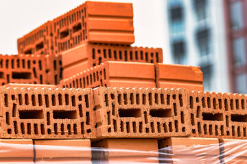 Red ceramic bricks at the construction site. Keramoblock. Hollow brick. Construction of a red brick...