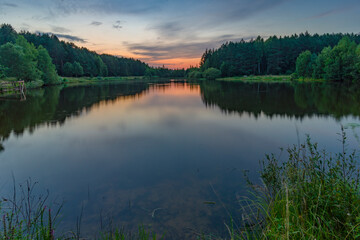 Twilight over small forest lake
