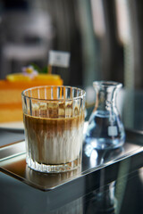 Dirty coffee menu in coffee shop, a shot of dark espresso or ristretto poured gently over cold milk or cream