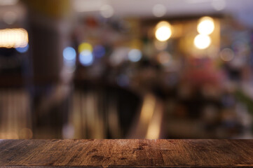 Empty dark wooden table in front of abstract blurred bokeh background of restaurant . can be used for display or montage your products.Mock up for space.