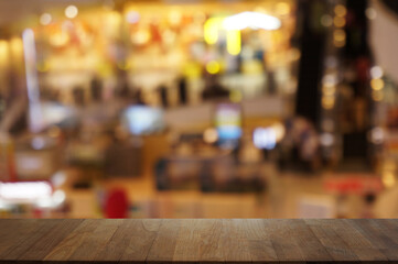 Empty dark wooden table in front of abstract blurred bokeh background of restaurant . can be used for display or montage your products.Mock up for space.