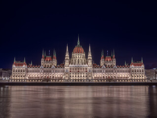 Fototapeta na wymiar Budapest, Hungary - The beautiful illuminated Hungarian Parliament building (Orszaghaz) by night with dark blue sky and River Danube