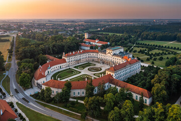 Fertod, Hungary - Aerial view of the beautiful Esterhazy Castle (Esterhazy-kastely) and garden in the Town of Fertod, near Sopron on a sunny summer morning with golden sky at sunrise - obrazy, fototapety, plakaty