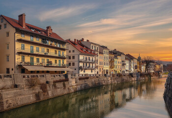 Ljubljana, Slovenia - Beautiful sunset over the old town of Ljubljana with Ljubljanica river and traditional Slovenian houses on a sunny winter afternoon