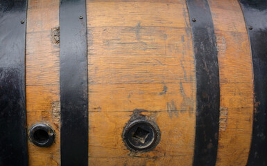 Background with the texture of an old oak barrel with black metal hoops