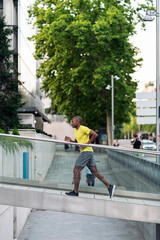 African American sportsman running up on ramp building outdoors