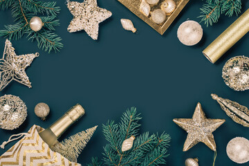 Merry Christmas and Happy New Year rich golden and crystal baubles festive ornaments. stars glitter and Christmas tree branches with cones on teal green. Party decor banner. Top view