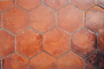 Hexagonal vermilion floor tiles inside a traditional Chinese building