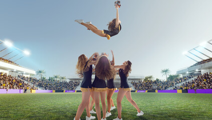 Group of cheerleaders in action on  stadium