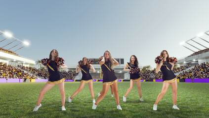 Group of cheerleaders in action on  stadium