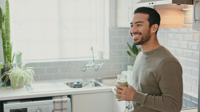 Happy man, healthy smoothie and green juice drink in kitchen for breakfast, nutrition and morning energy. Smile young guy drinking whey protein supplement, detox diet and fruit cleanse for wellness