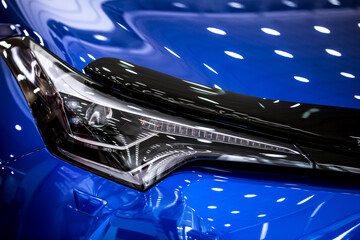 Toyota. Headlight of modern prestigious car close up. Brilliant glass car headlight with highlights...