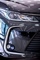 Toyota. Headlight of modern prestigious car close up. Brilliant glass car headlight with highlights from the lighting in the showroom. Sale of new commercial cars. Shymkent Kazakhstan April 15, 2022