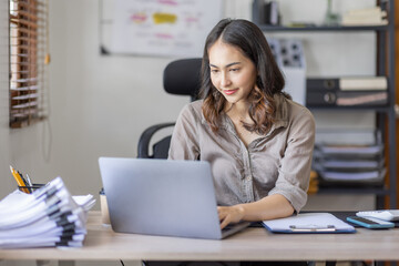 Young Asian businesswoman attending a virtual working financial report analysis Business Documents in workplace an home office, asian woman working contract.