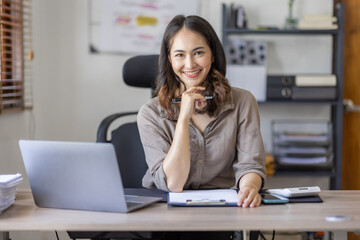 Young Asian businesswoman attending a virtual working financial report analysis Business Documents in workplace an home office, asian woman working contract.