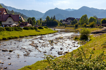 Panorama of Pieniny Mountains over Grajcarek creek joining Dunajec river in Szczawnica Zdroj springs resort town in Lesser Poland