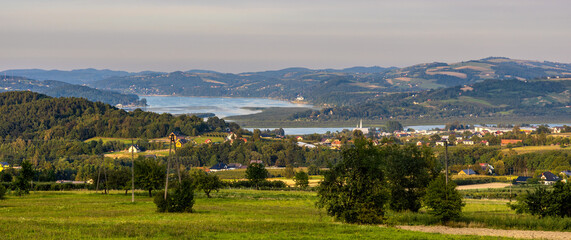 Fototapeta premium Panorama of Pieniny and Gorce Mountains over Zalew Czorsztynski Reservoir at Dunajec seen from Tylmanowa village river in Lesser Poland
