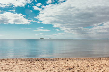 Beautiful shore, beach. Sea, lake, freshwater reservoir. Water and sand, blue sky. Vacation.