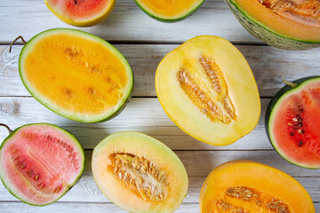Variety of melons and water melons on wooden surface. Food backgrounds.