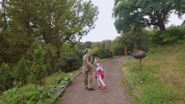 Ukrainian military dad returned home to his daughter. The military man and the little girl go hand in hand.