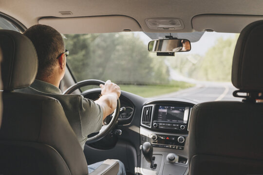 Young Man Holding Steering Wheel While Driving Car. Road Trip. Local Travel Concept. Thirst For Adventure.