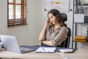 Fototapeta na wymiar Asian indian women are stressed while working on laptop, Tired asian businesswoman with headache at office, feeling sick at work copy space in workplace an home office.
