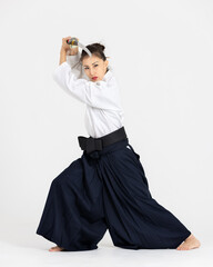 Aikido master woman in traditional samurai hakama kimono with black belt with sword, katana on...