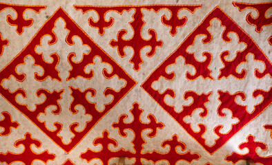 Ethnic ornaments made of wool. National traditional carpet felting. Asian ornament, vintage weaving...