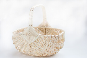 empty wicker basket made of vines on a white background. Easter Item