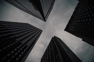 Low angle shot of modern high-rise buildings against a cloudy sky in Chicago, Illinois, USA © Anthony Labriola/Wirestock Creators