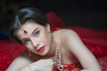 Beautiful portrait fashion of a young Asian woman in traditional Hindu Red Saree wedding clothes...