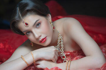 Beautiful portrait fashion of a young Asian woman in traditional Hindu Red Saree wedding clothes...
