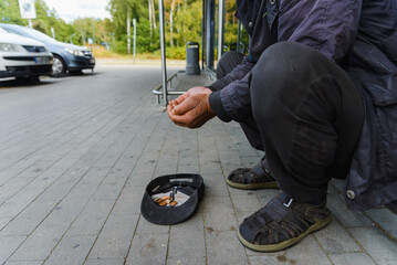 Begging. Outstretched hands.A real homeless person. Diminution of money. Poor man. A beggar in the...