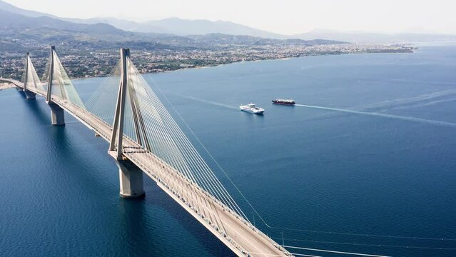Aerial drone shot of cable strayed bridge over sea also known as Charilaos Trikoupis Rio - Antirio bridge which connects Greece mainland with Peloponnese.