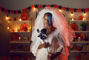 Portrait of woman dressed up as Dead Bride or Corpse Bride at Halloween costume party. Serious...