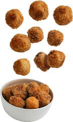 Homemade croquettes falling into a bowl