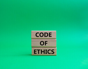 Code of ethics symbol. Concept words Code of ethics on wooden blocks. Beautiful green background. Business and Code of ethics concept. Copy space.
