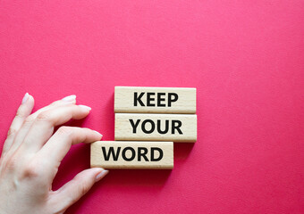 Keep your word symbol. Wooden blocks with words Keep your word. Beautiful red background....