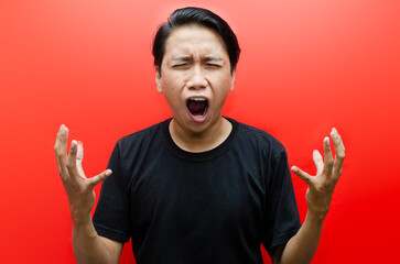 asian man screaming madly and angrily - obrazy, fototapety, plakaty