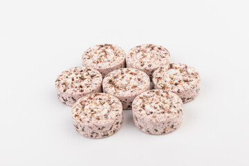 Heap of medicine colored pills, tablets on a white background