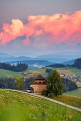 classical Emmental farmhouse at a summer sunset