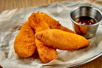 Breaded chicken nuggets. A selective trick. Close-up. Noise added in post-production