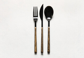 Fork, knife and spoon on white background