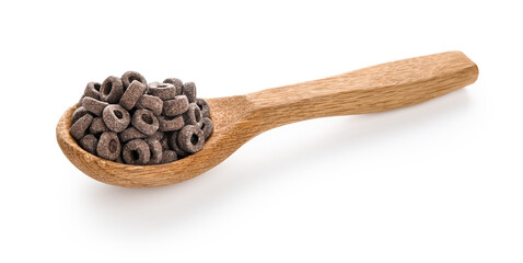 Wooden spoon with black cereal rings on white background