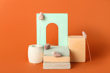 Composition with showcase pedestals and floral decor on brown background