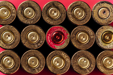 Small caliber cartridges on a red background.