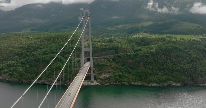 Aerial View Of Hardanger Bridge And Tunnel Across Eidfjorden In Norway. drone shot